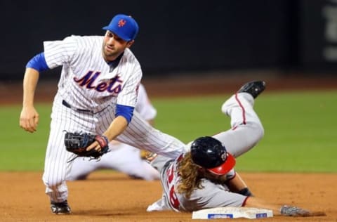 Jul 7, 2016; New York City, NY, USA; New York Mets second baseman Neil Walker (20) forces out Washington Nationals left fielder Jayson Werth (28) and throws to first to attempt a double play during the ninth inning at Citi Field. The umpires called a double play on the play when Werth slid past the base, taking out Walker. Mandatory Credit: Brad Penner-USA TODAY Sports