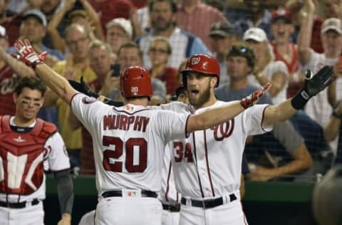 Aug 26, 2016; Washington, DC, USA; Washington Nationals second baseman Daniel Murphy (20) celebrates with right fielder Bryce Harper (34) and his fifth inning solo home run against the Colorado Rockies at Nationals Park. Mandatory Credit: Tommy Gilligan-USA TODAY Sports