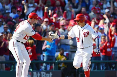 Oct 9, 2016; Washington, DC, USA; Washington Nationals catcher Jose Lobaton (59) is congratulated by third base coach Bob Henley (13) after hitting a three run home run against the Los Angeles Dodgers during the fourth inning during game two of the 2016 NLDS playoff baseball series at Nationals Park. Mandatory Credit: Brad Mills-USA TODAY Sports