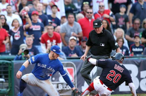 Oct 15, 2016; Cleveland, OH, USA; Cleveland Indians center fielder Rajai Davis (20) reaches third base on a past ball against Toronto Blue Jays third baseman Josh Donaldson (20) during the third inning of game two of the 2016 ALCS playoff baseball series at Progressive Field. Mandatory Credit: Charles LeClaire-USA TODAY Sports