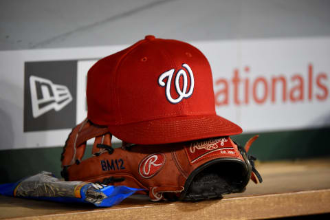 A general view of a Washington Nationals baseball hat on top of a Rawlings baseball glove during the game against the Philadelphia Phillies at Nationals Park on September 25, 2019 in Washington, DC. (Photo by Will Newton/Getty Images)