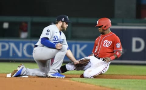 Max Muncy #13 of the Los Angeles Dodgers tags out Victor Robles #16 of the Washington Nationals in the seventh inning trying to steal second base during a baseball game at Nationals Park on July 3, 2021 in Washington, DC. (Photo by Mitchell Layton/Getty Images)