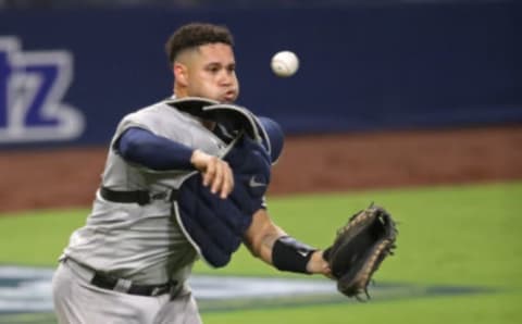 Gary Sanchez #24 of the New York Yankees throws out the runner against the Tampa Bay Rays during the fifth inning in Game Two of the American League Division Series at PETCO Park on October 06, 2020 in San Diego, California. (Photo by Christian Petersen/Getty Images)