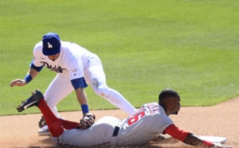 Victor Robles #16 of the Washington Nationals is caught stealing by Gavin Lux #9 of the Los Angeles Dodgers in the eighth inning during the 2021 MLB season home opening game at Dodger Stadium on April 09, 2021 in Los Angeles, California. (Photo by Harry How/Getty Images)