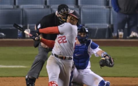 Juan Soto #22 of the Washington Nationals hits a two run homerun in front of Will Smith #16 of the Los Angeles Dodgers, his second homerun of the game, to trail 9-5, during the ninth inning at Dodger Stadium on April 10, 2021 in Los Angeles, California. (Photo by Harry How/Getty Images)