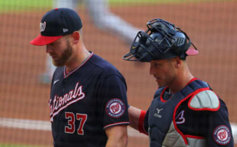 Stephen Strasburg #37 and Yan Gomes #10 of the Washington Nationals walk off the field after the first inning against the Atlanta Braves at Truist Park on June 01, 2021 in Atlanta, Georgia. (Photo by Kevin C. Cox/Getty Images)