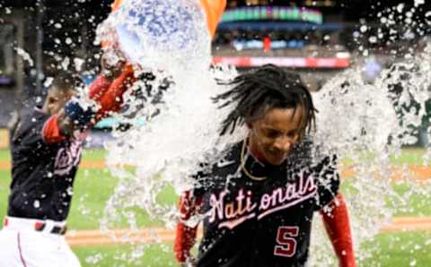 WASHINGTON, DC – SEPTEMBER 28: CJ Abrams #5 of the Washington Nationals gets doused with water by Victor Robles #16 after driving in the game winning run with a single in the tenth inning against the Atlanta Braves at Nationals Park on September 28, 2022 in Washington, DC. (Photo by G Fiume/Getty Images)