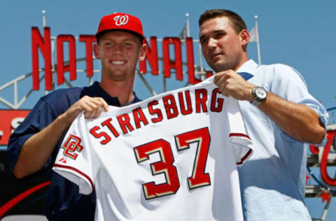 WASHINGTON – AUGUST 21: Stephen Strasburg (L), the overall first pick in the 2009 MLB Draft, is presented with his jersey by Nationals third baseman Ryan Zimmerman (R) after being introduced at Nationals Park August 21, 2009 in Washington, DC. Strasburg, a right handed pitcher from San Diego State University, signed with the Nationals earlier this week wth a record contract for an amateur player. (Photo by Win McNamee/Getty Images)