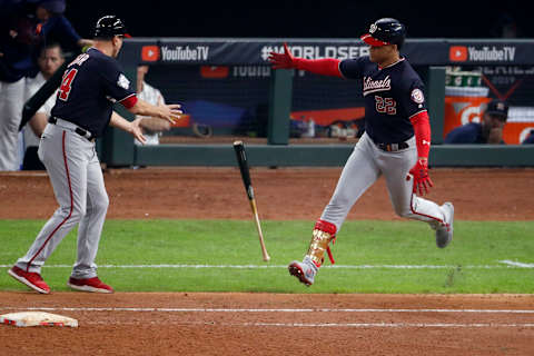 HOUSTON, TEXAS – OCTOBER 29: Juan  Soto #22 of the Washington Nationals tosses the bat toward first base coach Tim Bogar #24 after hitting a solo home run against the Houston Astros during the fifth inning in Game Six of the 2019 World Series at Minute Maid Park on October 29, 2019 in Houston, Texas. (Photo by Tim Warner/Getty Images)