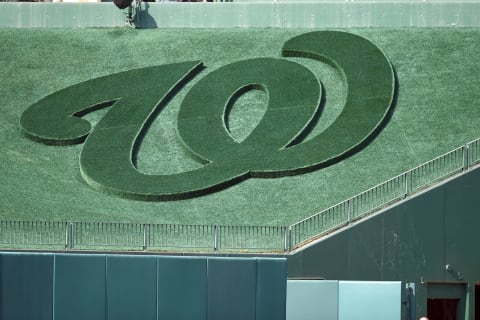 The Washington Nationals logo in centerfield grass before a baseball game against the Los Angeles Dodgers at Nationals Park on July 26, 2019 in Washington, DC. (Photo by Mitchell Layton/Getty Images) *** Local Caption ***