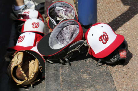 Mar 21, 2016; Melbourne, FL, USA; Washington Nationals player hats and gloves sit inside the dugout in the ninth inning against the Houston Astros at Space Coast Stadium. The Washington Nationals won 5-3. Mandatory Credit: Logan Bowles-USA TODAY Sports