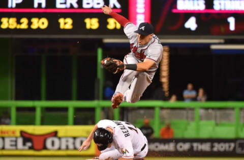 Sep 22, 2016; Miami, FL, USA; Atlanta Braves second baseman Jace Peterson (8) leaps over Miami Marlins catcher J.T. Realmuto (11) after the force out at second base at Marlins Park. The Atlanta Braves defeat the Miami Marlins 6-3. Mandatory Credit: Jasen Vinlove-USA TODAY Sports