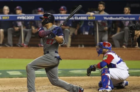 Mar 11, 2017; Miami, FL, USA; United States outfielder Giancarlo Stanton (27) hits a single in the sixth inning against the Dominican Republic during the 2017 World Baseball Classic at Marlins Park. Dominican Republic wins 7-5. Mandatory Credit: Logan Bowles-USA TODAY Sports