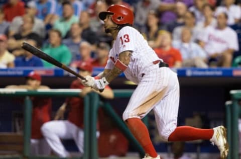 Sep 13, 2016; Philadelphia, PA, USA; Philadelphia Phillies shortstop Freddy Galvis (13) hits an RBI sacrifice fly during the eighth inning against the Pittsburgh Pirates at Citizens Bank Park. The Pittsburgh Pirates won 5-3. Mandatory Credit: Bill Streicher-USA TODAY Sports