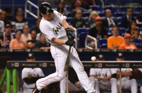 Sep 22, 2016; Miami, FL, USA; Miami Marlins catcher J.T. Realmuto (11) connects for a solo home run in the seventh inning against the Atlanta Braves at Marlins Park. The Atlanta Braves defeat the Miami Marlins 6-3. Mandatory Credit: Jasen Vinlove-USA TODAY Sports