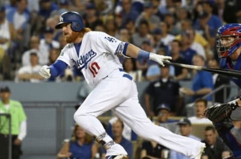 Oct 20, 2016; Los Angeles, CA, USA; Los Angeles Dodgers third baseman Justin Turner (10) connects for a single in the third inning against the Chicago Cubs in game five of the 2016 NLCS playoff baseball series against the Los Angeles Dodgers at Dodger Stadium. Mandatory Credit: Richard Mackson-USA TODAY Sports