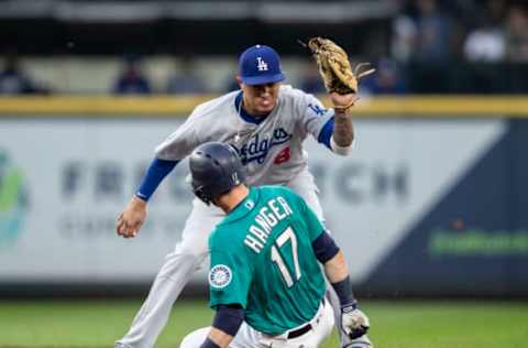 SEATTLE, WA – AUGUST 17: Shortstop Manny Machado #8 of the Los Angeles Dodgers tries to put a tag on Mitch Haniger #17 of the Seattle Mariners at second base during the third inning of a game at Safeco Field on August 17, 2018, in Seattle, Washington. Haniger was safe on the play after second baseman Brian Dozier #6 of the Los Angeles Dodgers dropped a pop fly in short right field. The Dodgers won the game 11-1. (Photo by Stephen Brashear/Getty Images)