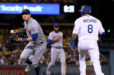 LOS ANGELES, CA – SEPTEMBER 04: Wilmer Flores #4 of the New York Mets fields a ground ball in front of Manny Machado #8 of the Los Angeles Dodgers leading to an out of Matt Kemp #27 to end the third inning at Dodger Stadium on September 4, 2018 in Los Angeles, California. (Photo by Harry How/Getty Images)