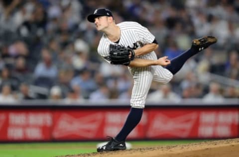 NEW YORK, NEW YORK – OCTOBER 09: David Robertson #30 of the New York Yankees pitches in the sixth inning against the Boston Red Sox during Game Four American League Division Series at Yankee Stadium on October 09, 2018 in the Bronx borough of New York City. (Photo by Elsa/Getty Images)