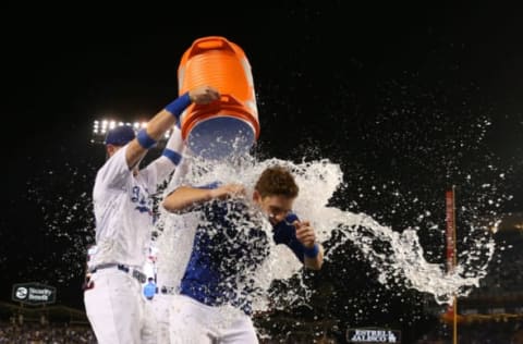 LOS ANGELES, CALIFORNIA – JUNE 01: Will Smith #16 of the Los Angeles Dodgers is doused with a bucket of water by teammates Cody Bellinger #35 and Joc Pederson #31 after Smith hit a walk-off home run in the ninth inning of the MLB game against the Philadelphia Phillies at Dodger Stadium on June 01, 2019 in Los Angeles, California. The Dodgers defeated the Phillies 4-3. (Photo by Victor Decolongon/Getty Images)