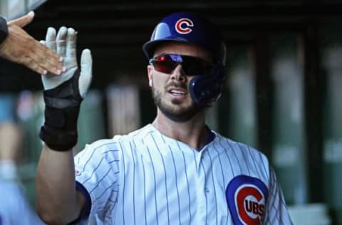 CHICAGO, ILLINOIS – JULY 12: Kris Bryant #17 of the Chicago Cubs is congratulated by teammates in the dugout after scoring the game-winning run in the 8th inning against the Pittsburgh Pirates at Wrigley Field on July 12, 2019 in Chicago, Illinois. The Cubs defeated the Pirates 4-3. (Photo by Jonathan Daniel/Getty Images)