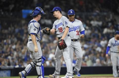 SAN DIEGO, CA – SEPTEMBER 24: Kenta Maeda #18 of the Los Angeles Dodgers is congratulated by Will Smith #16 as Dave Roberts #30 look on after pitching during the seventh inning of a baseball game against the San Diego Padres at Petco Park September 24, 2019 in San Diego, California. (Photo by Denis Poroy/Getty Images)