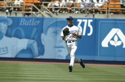 LOS ANGELES - JULY 16: Outfielder Shawn Green #15 of the Los Angeles Dodgers runs in from the outfield during the game against the St. Louis Cardinals in their game on July 16, 2002 at Dodger Stadium in Los Angeles, California. The Cardinals won 9-2. (Photo by Stephen Dunn/Getty Images)