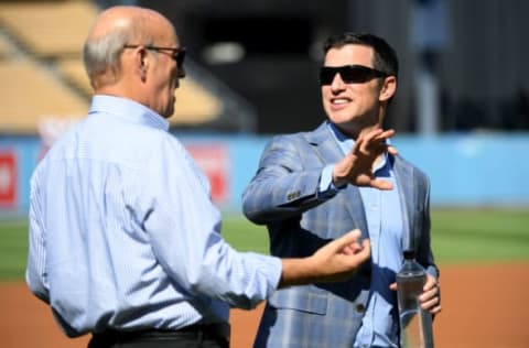 LOS ANGELES, CALIFORNIA – OCTOBER 03: President and part-owner of the Los Angeles Dodgers, Stan Kasten, speaks to President of Baseball Operations for the Los Angeles Dodgers, Andrew Friedman, before game one of the National League Division Series against the Washington Nationals at Dodger Stadium on October 03, 2019 in Los Angeles, California. (Photo by Harry How/Getty Images)