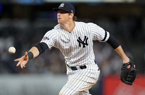 NEW YORK, NEW YORK - OCTOBER 05: DJ LeMahieu #26 of the New York Yankees tosses the ball to first base for an out on a ball hit by Jake Cave #60 of the Minnesota Twins in the fifth inning of game two of the American League Division Series at Yankee Stadium on October 05, 2019 in New York City. (Photo by Elsa/Getty Images)