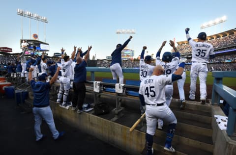 LOS ANGELES, CALIFORNIA - OCTOBER 09: The Los Angeles Dodgers dug out celebrate after Max Muncy #13 hit a two run home run in the first inning of game five of the National League Division Series against the Washington Nationals at Dodger Stadium on October 09, 2019 in Los Angeles, California. (Photo by Harry How/Getty Images)