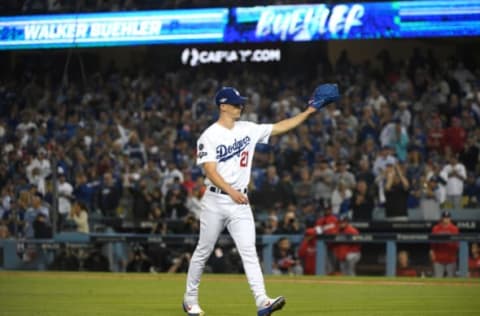 LOS ANGELES, CALIFORNIA – OCTOBER 09: Walker Buehler #21 of the Los Angeles Dodgers acknowledges the crowd after being pulled in the seventh inning of game five of the National League Division Series against the Washington Nationals at Dodger Stadium on October 09, 2019 in Los Angeles, California. (Photo by Harry How/Getty Images)