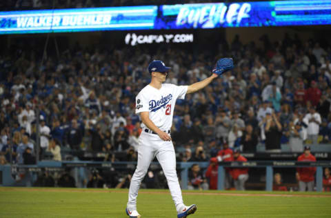 LOS ANGELES, CALIFORNIA - OCTOBER 09: Walker Buehler #21 of the Los Angeles Dodgers acknowledges the crowd after being pulled in the seventh inning of game five of the National League Division Series against the Washington Nationals at Dodger Stadium on October 09, 2019 in Los Angeles, California. (Photo by Harry How/Getty Images)