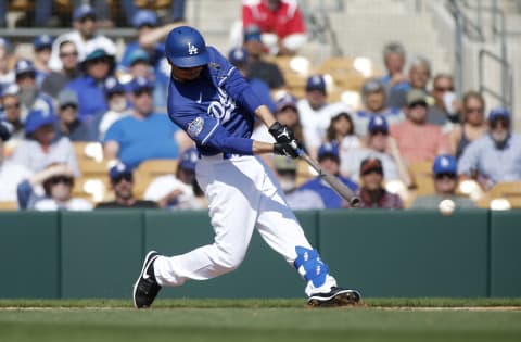 GLENDALE, ARIZONA – FEBRUARY 24: Mookie Betts #50 of the Los Angeles Dodgers hits a ground ball against the Chicago White Sox during the third inning of a Cactus League spring training game at Camelback Ranch on February 24, 2020 in Glendale, Arizona. (Photo by Ralph Freso/Getty Images)