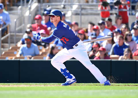 Zach McKinstry #73 of the Los Angeles Dodgers follows through on a swing during a spring training game. (Photo by Norm Hall/Getty Images)