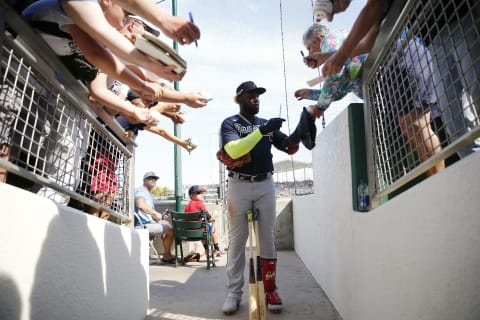 FORT MYERS, FLORIDA – MARCH 01: Marcell Ozuna #20 of the Atlanta Braves signs a autograph for a fan against the Boston Red Sox during a Grapefruit League spring training game at JetBlue Park at Fenway South on March 01, 2020 in Fort Myers, Florida. (Photo by Michael Reaves/Getty Images)