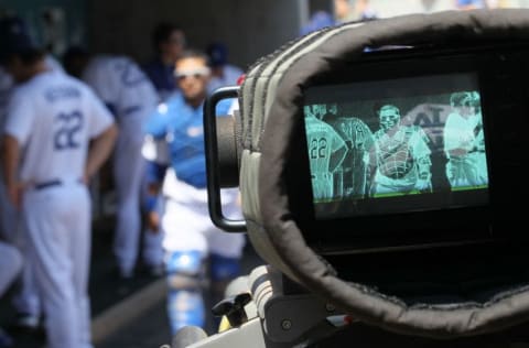 LOS ANGELES, CA - AUGUST 14: A television camera focuses on catcher Dioner Navarro #30 of the Los Angeles Dodgers in the dugout before the game with the Houston Astros on August 14, 2011 at Dodger Stadium in Los Angeles, California. The Dodgers won 7-0. (Photo by Stephen Dunn/Getty Images)