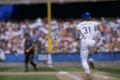 29 May 1997: Mike Piazza of the Los Angeles Dodgers runs to first base during the Dodgers 2-0 win over the Atlanta Braves at Dodger Stadium in Los Angeles, California. Mandatory Credit: Jose L. Marin /Allsport