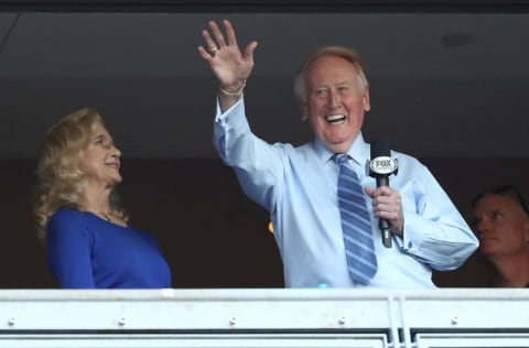 LOS ANGELES, CA - OCTOBER 20: Los Angeles Dodgers broadcaster Vin Scully waves to the crowd alongside his wife Sandra Hunt before the Dodgers take on the Chicago Cubs in game five of the National League Division Series at Dodger Stadium on October 20, 2016 in Los Angeles, California. (Photo by Sean M. Haffey/Getty Images)