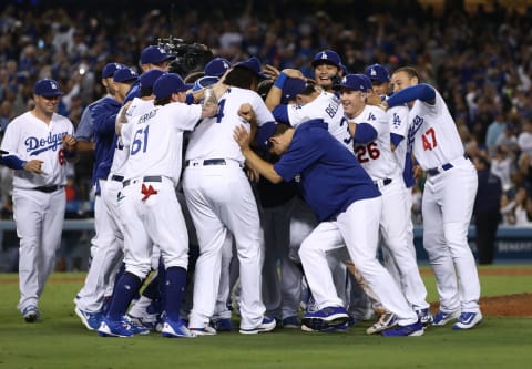 LOS ANGELES, CA – SEPTEMBER 22: Closing pitcher Kenley Jansen #74 of the Los Angeles Dodgers is mobbed by his teammates after their 4-2 win in an MLB game against the San Francisco Giants to clinch their fifth consecutive National League West title at Dodger Stadium on September 22, 2017 in Los Angeles, California. The Dodgers defeated the San Francisco Giants 4-2 to clinch their fifth straight National League West title. (Photo by Victor Decolongon/Getty Images)