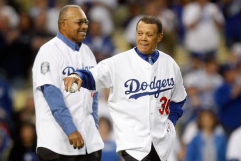 LOS ANGELES, CA – OCTOBER 07: (R-L) Former Los Angeles Dodgers Maury Wills and Tommy Davis throw out the first pitch (Photo by Jeff Gross/Getty Images)