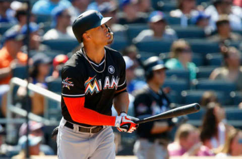 NEW YORK, NY – AUGUST 20: Giancarlo Stanton #27 of the Miami Marlins watches the flight of his seventh inning three run home run against the New York Mets at Citi Field on August 20, 2017, in the Flushing neighborhood of the Queens borough of New York City. (Photo by Jim McIsaac/Getty Images)