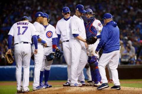 CHICAGO, IL – OCTOBER 11: Manager Joe Maddon of the Chicago Cubs relieves Jon Lester