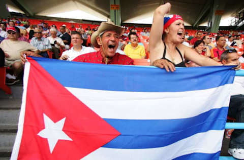 SAN JUAN, PR – MARCH 8: Fans of Cuba display a Cuban flag as they cheer their team during their game against Panama at the World Baseball Classic at Hiram Bithorn Stadium on March 8, 2006, in San Juan, Puerto Rico. (Photo by Al Bello/Getty Images)