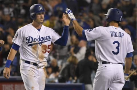 LOS ANGELES, CA – MARCH 31: First baseman Cody Bellinger #35 of the Los Angeles Dodgers and center fielder Chris Taylor #3 celebrate after Bellinger was driven in by catcher Kyle Farmer #17 in the 4th inning of a game against the San Francisco Giants at Dodger Stadium on March 31, 2018 in Los Angeles, California. (Photo by John McCoy/Getty Images)