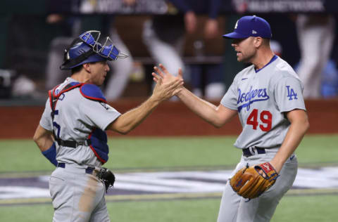 ARLINGTON, TEXAS - OCTOBER 25: Blake Treinen #49 and Austin Barnes #15 of the Los Angeles Dodgers celebrate the teams 4-2 victory against the Tampa Bay Rays in Game Five of the 2020 MLB World Series at Globe Life Field on October 25, 2020 in Arlington, Texas. (Photo by Tom Pennington/Getty Images)