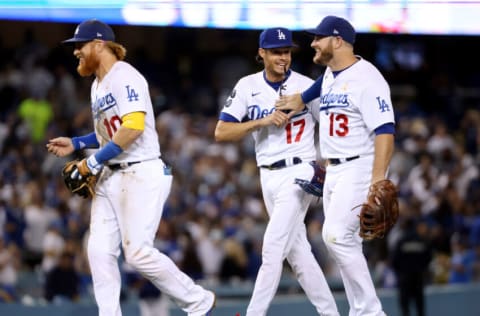 LOS ANGELES, CALIFORNIA - SEPTEMBER 01: Justin Turner #10, Joe Kelly #17 and Max Muncy #13 of the Los Angeles Dodgers celebrate a 4-3 win over the Atlanta Braves at Dodger Stadium on September 01, 2021 in Los Angeles, California. (Photo by Harry How/Getty Images)