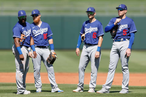 SURPRISE, ARIZONA – MARCH 31: (L-R) Infielders Hanser Alberto #17, Justin Turner #10, Trea Turner #6 and Freddie Freeman #5 of the Los Angeles Dodgers on the field during a pitching change in the fourth inning of the MLB spring training game against the Texas Rangers at Surprise Stadium on March 31, 2022 in Surprise, Arizona. (Photo by Christian Petersen/Getty Images)