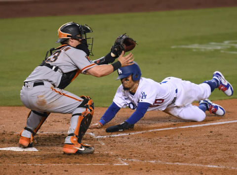 LOS ANGELES, CALIFORNIA – JULY 23: Mookie Betts #50 of the Los Angeles Dodgers slides safely home before the tag of Tyler Heineman #43 of the San Francisco Giants, to take a 2-1 lead during the seventh inning, on MLB Opening Day at Dodger Stadium on July 23, 2020 in Los Angeles, California. The 2020 season had been postponed since March due to the COVID-19 Pandemic. (Photo by Harry How/Getty Images)