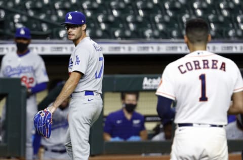 HOUSTON, TEXAS - JULY 28: Joe Kelly #17 of the Los Angeles Dodgers has words with Carlos Correa #1 of the Houston Astros as he walks towards the dugout at Minute Maid Park on July 28, 2020 in Houston, Texas. Both benches would empty after Kelly had thrown high inside pitches at Correa, Bregman and Guriel in the sixth inning. (Photo by Bob Levey/Getty Images)