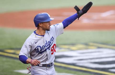 ARLINGTON, TEXAS - OCTOBER 14: Mookie Betts #50 of the Los Angeles Dodgers runs to first base against the Atlanta Braves during the first inning in Game Three of the National League Championship Series at Globe Life Field on October 14, 2020 in Arlington, Texas. (Photo by Tom Pennington/Getty Images)